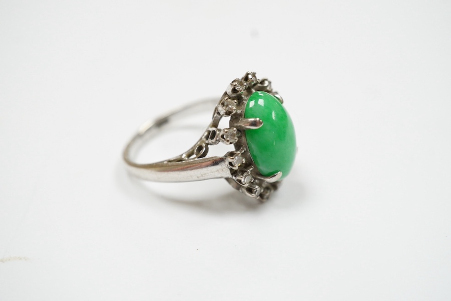 A white metal, jade and diamond set oval cluster ring, size N, gross weight 5.4 grams. Condition - fair to good